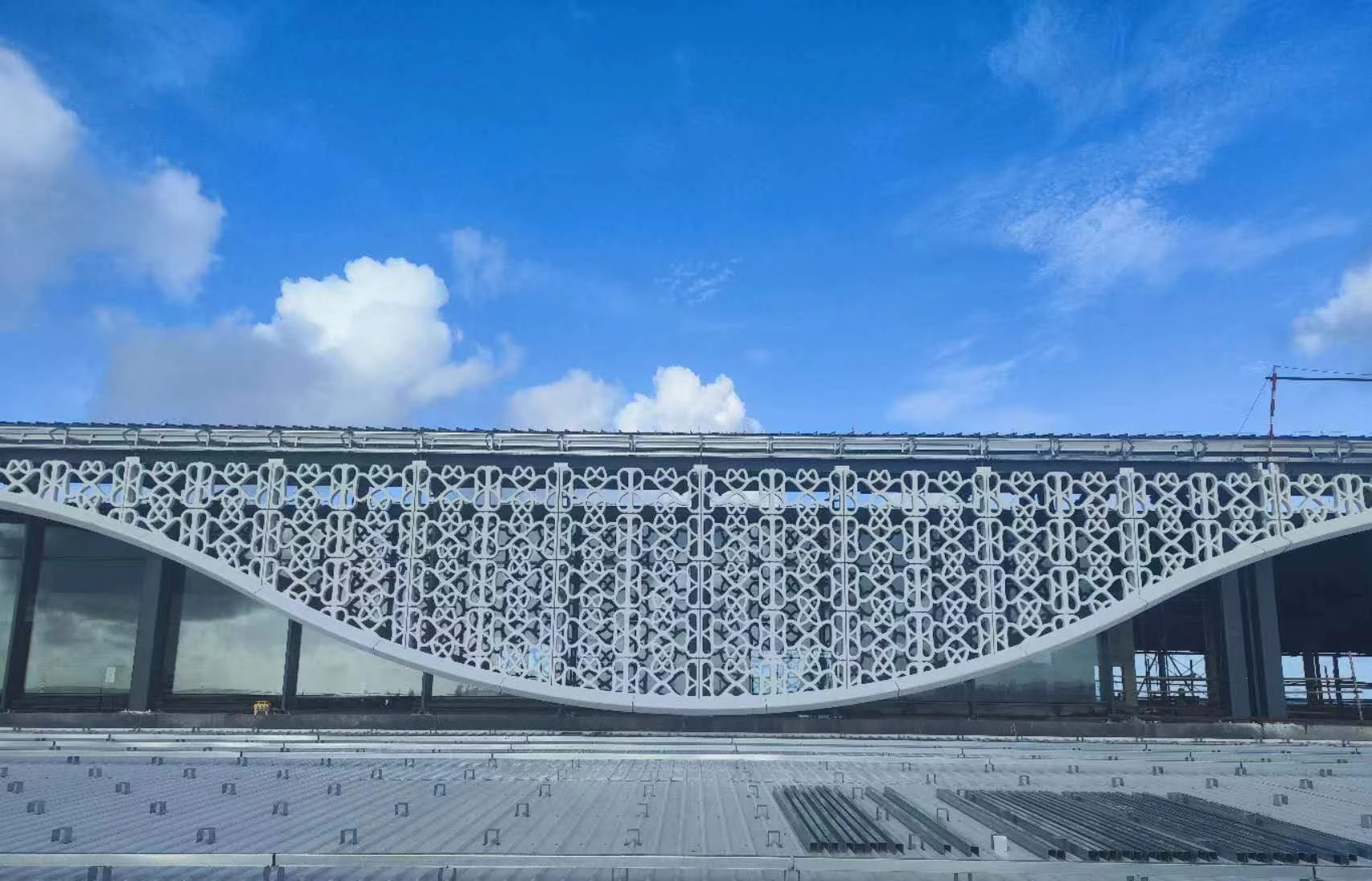 Detail view of the curved perforated architectural facade